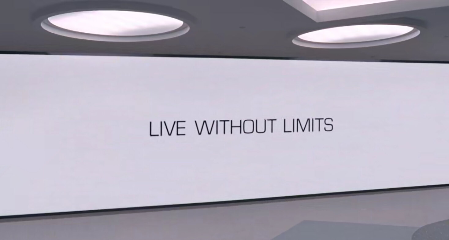 Wall display reading Live Without Limits under circular ceiling lights